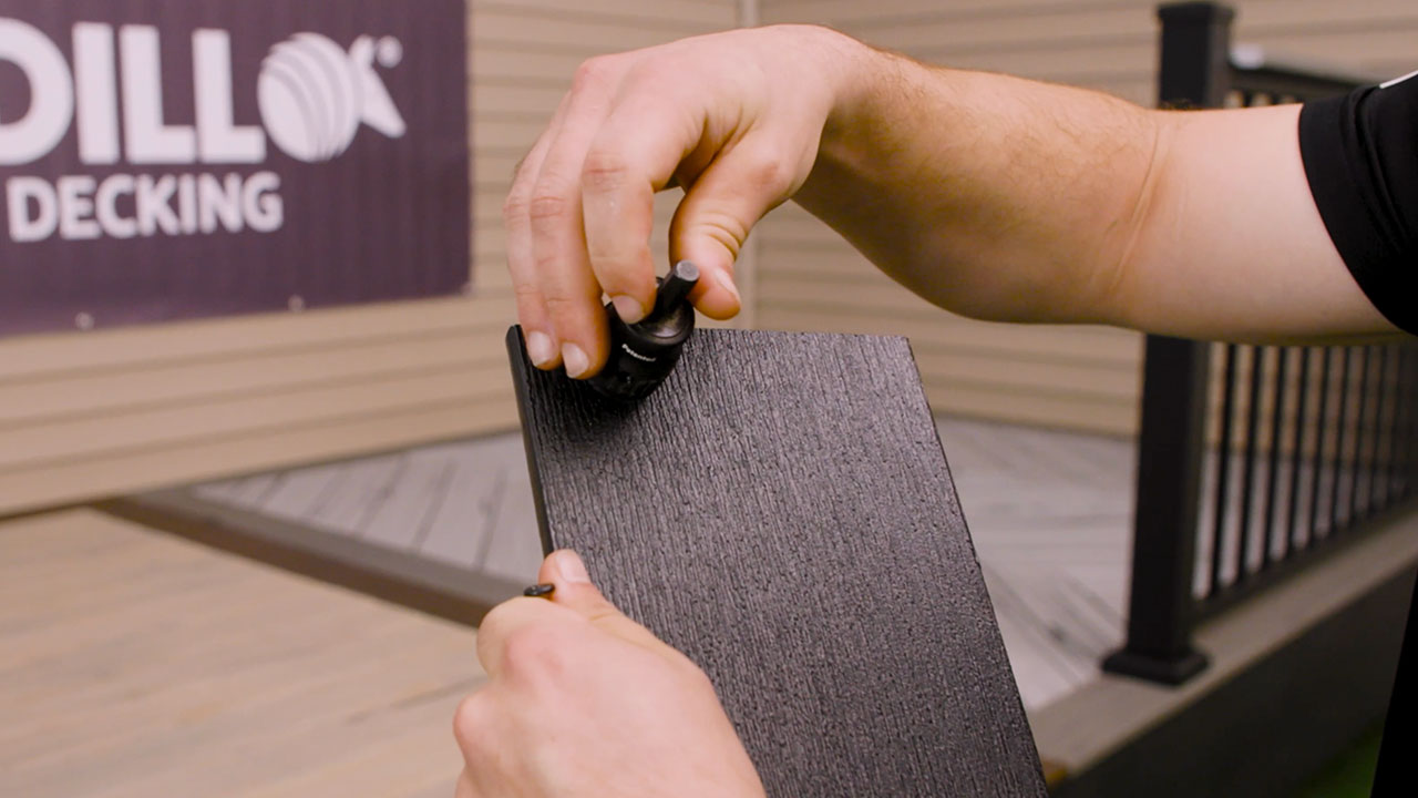 Derek holding fascia screw bit for installing composite deck fascia securely