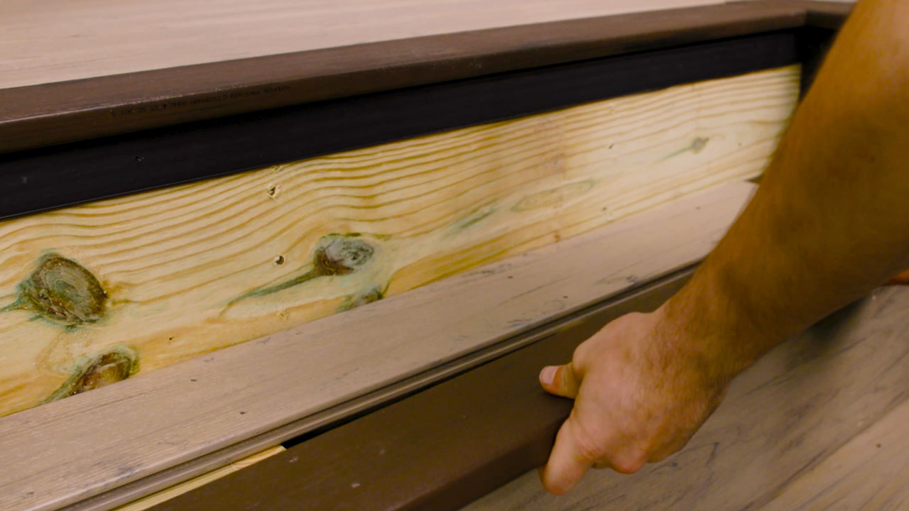 Derek placing composite deck treads and risers for picture frame deck pattern after precision cutting