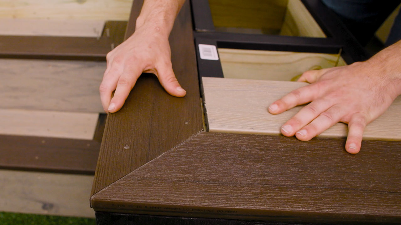 Picture framing and transition boards installed on composite decking for a professional, finished edge