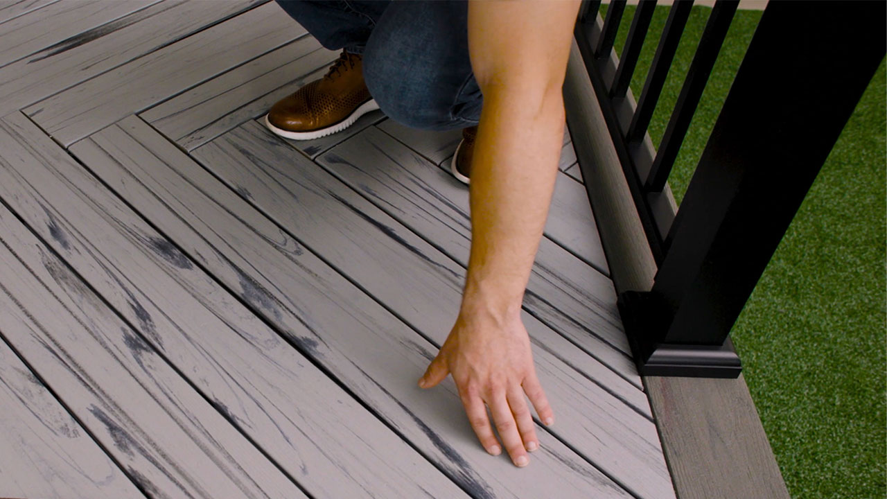 Derek demonstrating how to start a herringbone composite decking pattern correctly