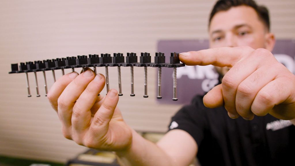 Derek holding TurboClip hidden fastener system used for installing composite deck boards